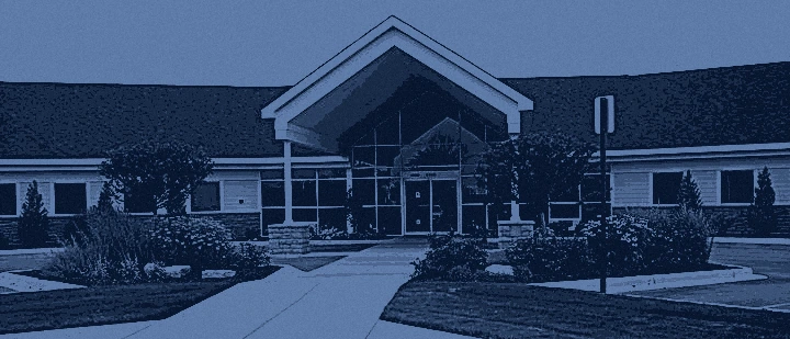 The Isabella Urgent Care building on East Bluegrass Road, rendered as a navy duotone plate.